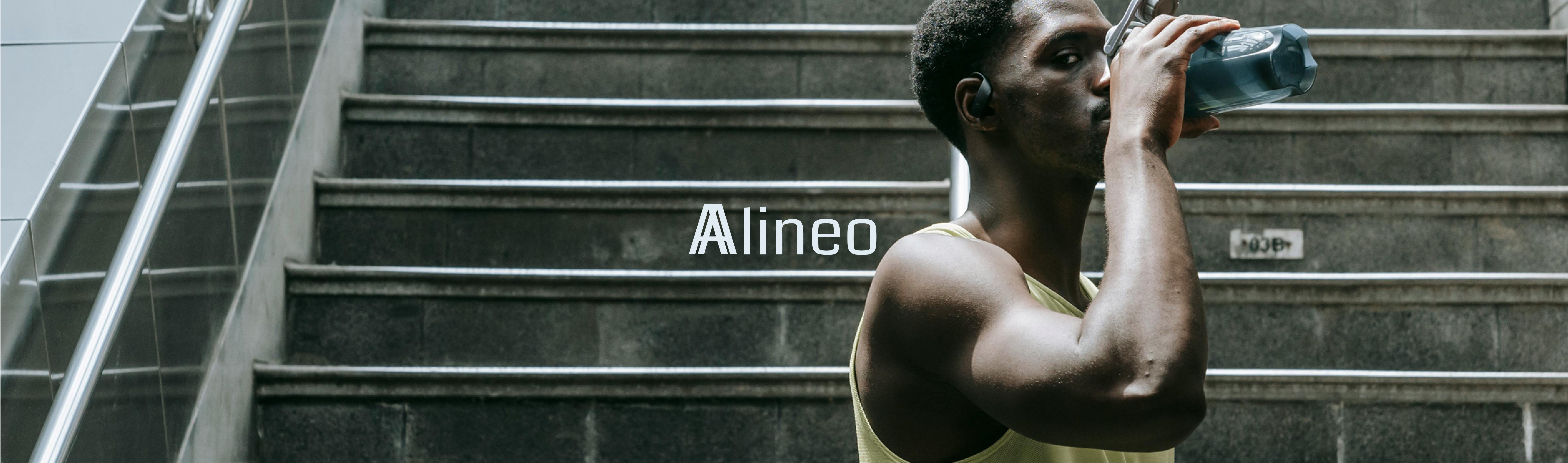 Alineo logo over a man in athletic wear drinking from a water bottle on concrete steps
